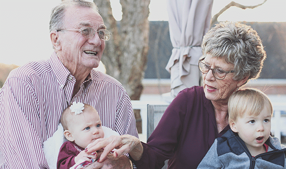 Grandparents holding grandchildren