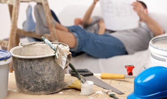 couple laying on bed looking at new house plan