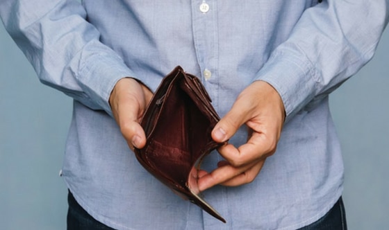 man holding open an empty wallet
