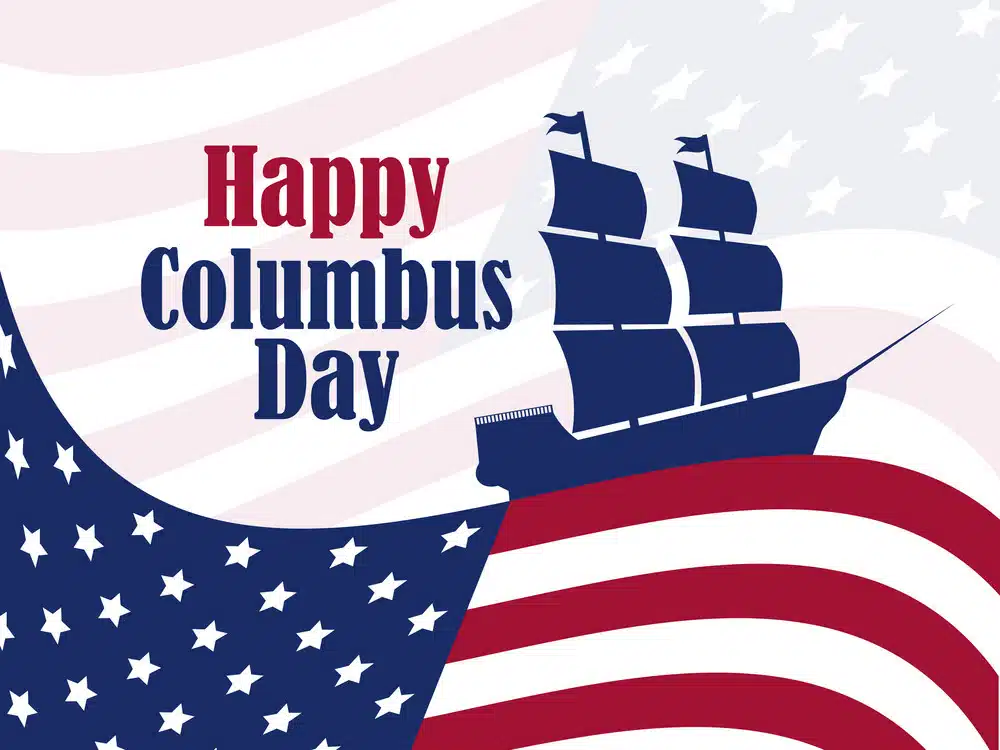 American flag wave to simulate the ocean with a colonial ship floating atop. Includes text "Happy Columbus Day"