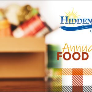 Box of canned good in foreground with can that has text "We CAN Make a Difference" as well as the HRCU logo and "Annual Fall Food Drive" text.