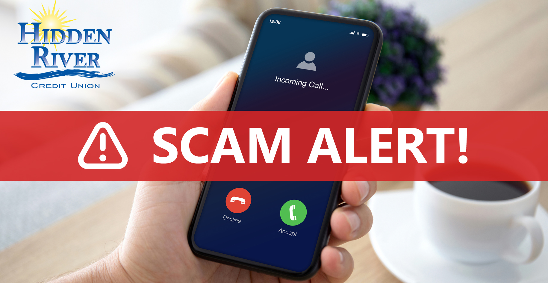 male hands holding phone with incoming call on the screen over a table in the room. Includes HRCU logo and text "Scam Alert!" in red.
