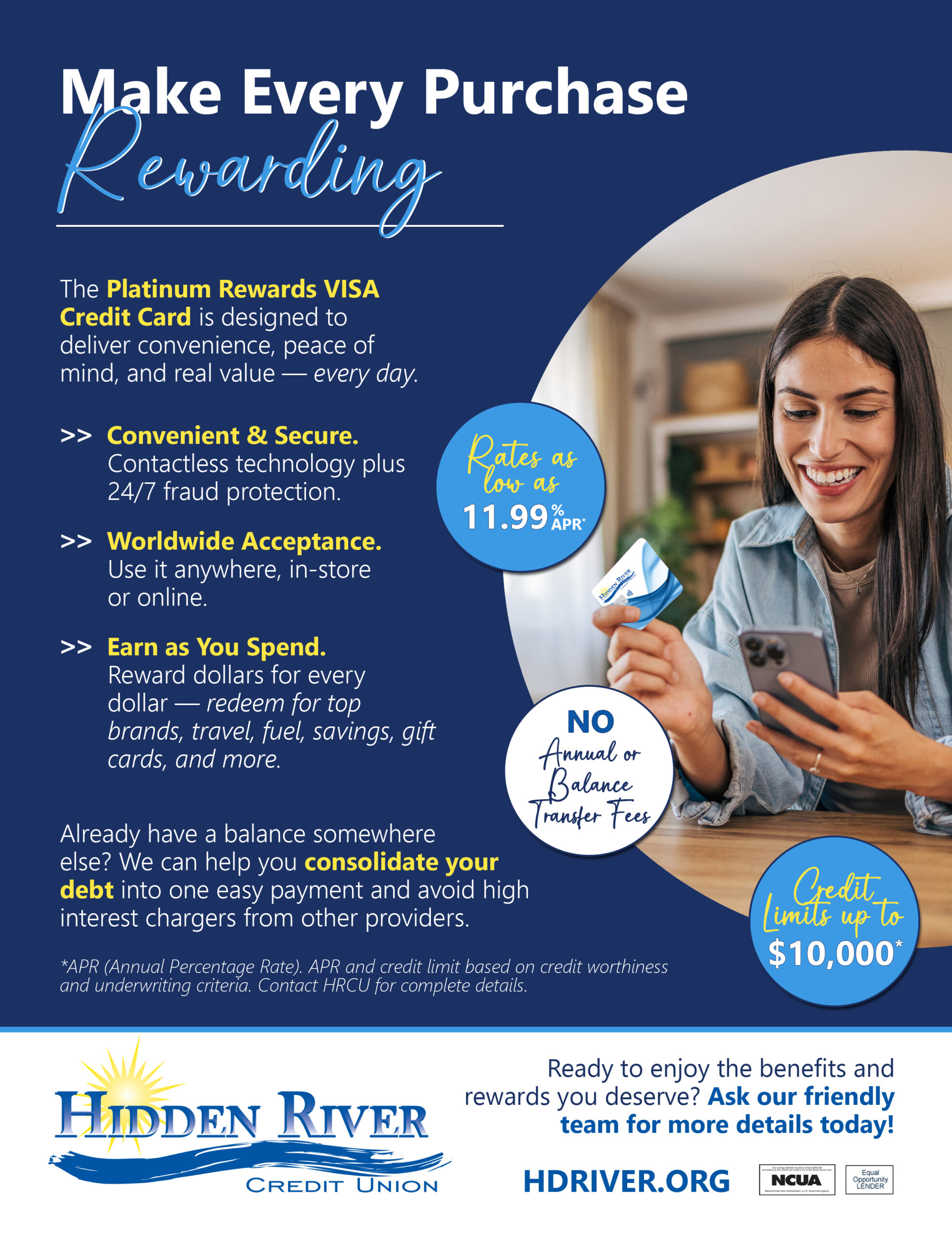 Woman looking at her phone while holding her credit card.