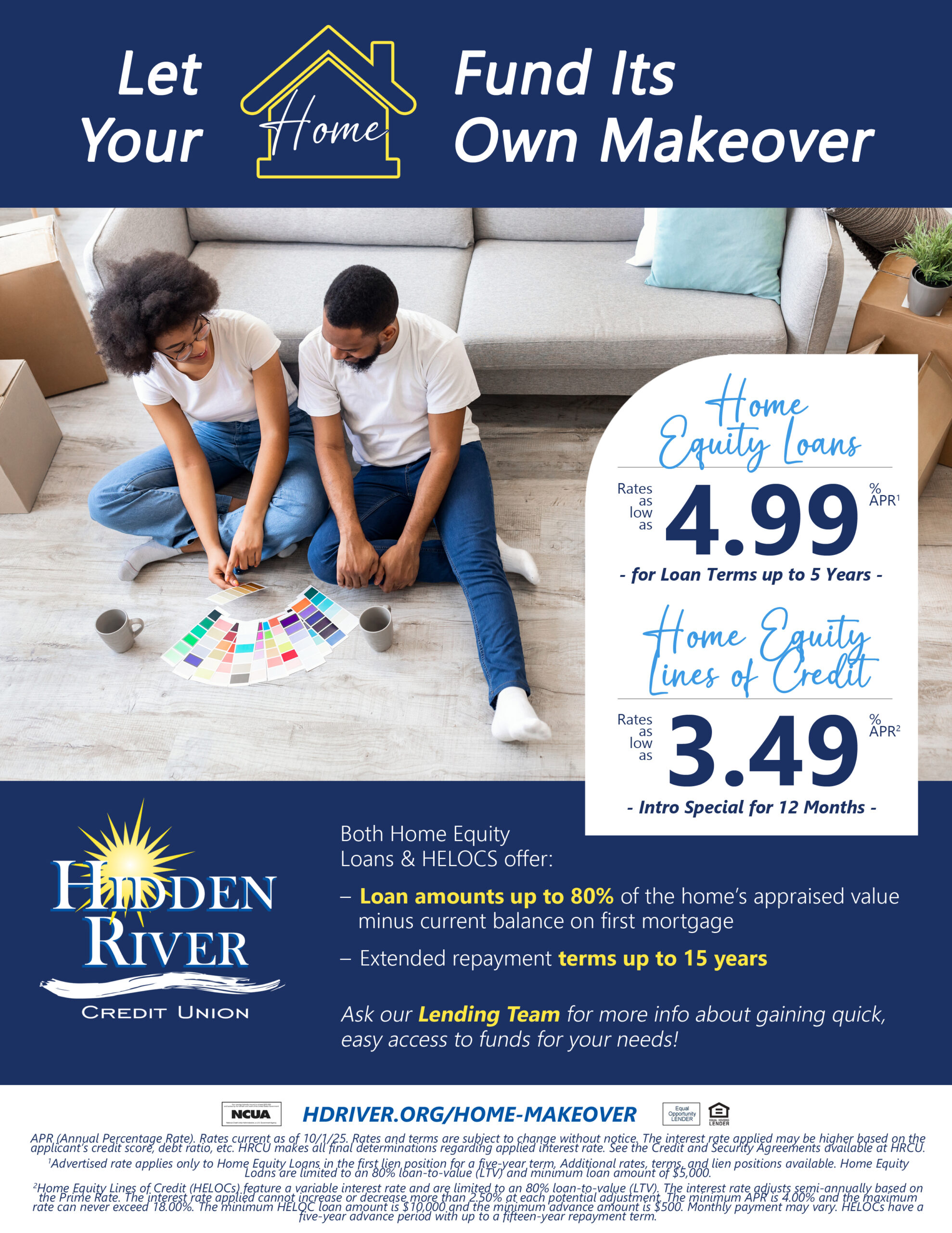 diverse couple sitting on living room floor and leaning against couch with paint samples sprawled out in front of them - surrounded by boxes.