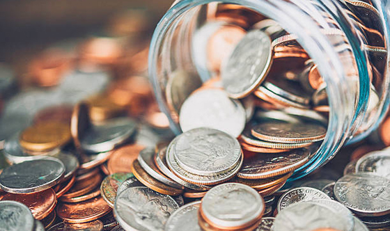 Money jar filled with American currency. Savings and donations concept.