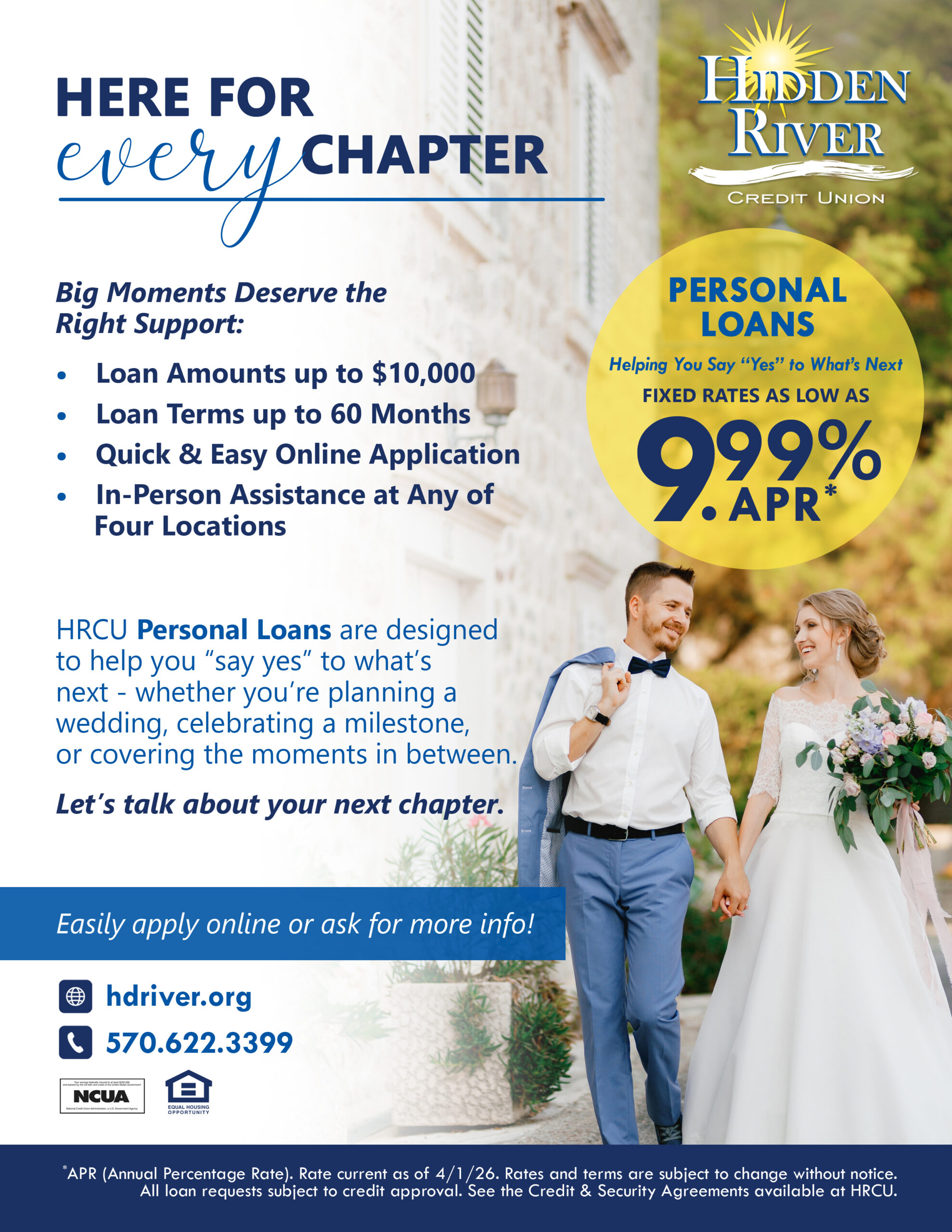 A newlywed couple standing next to and looking at each other smiling.