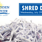 Pile of shredded paper with information regarding HRCU's Shred Day above.